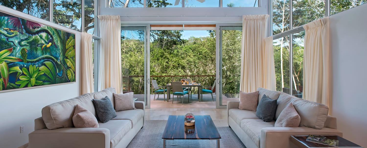 Ixchel Belize Villas interior living room with outdoor view at chaa creek resort