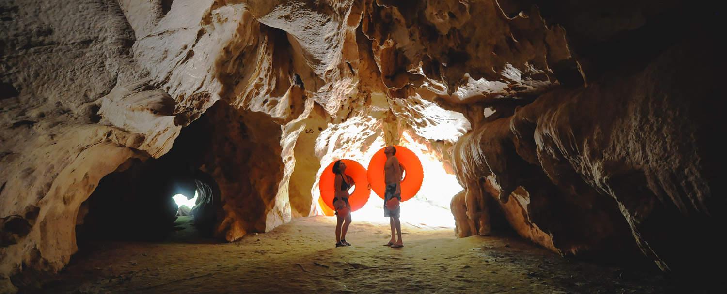 couple in cave on their way to cave tubing in belize