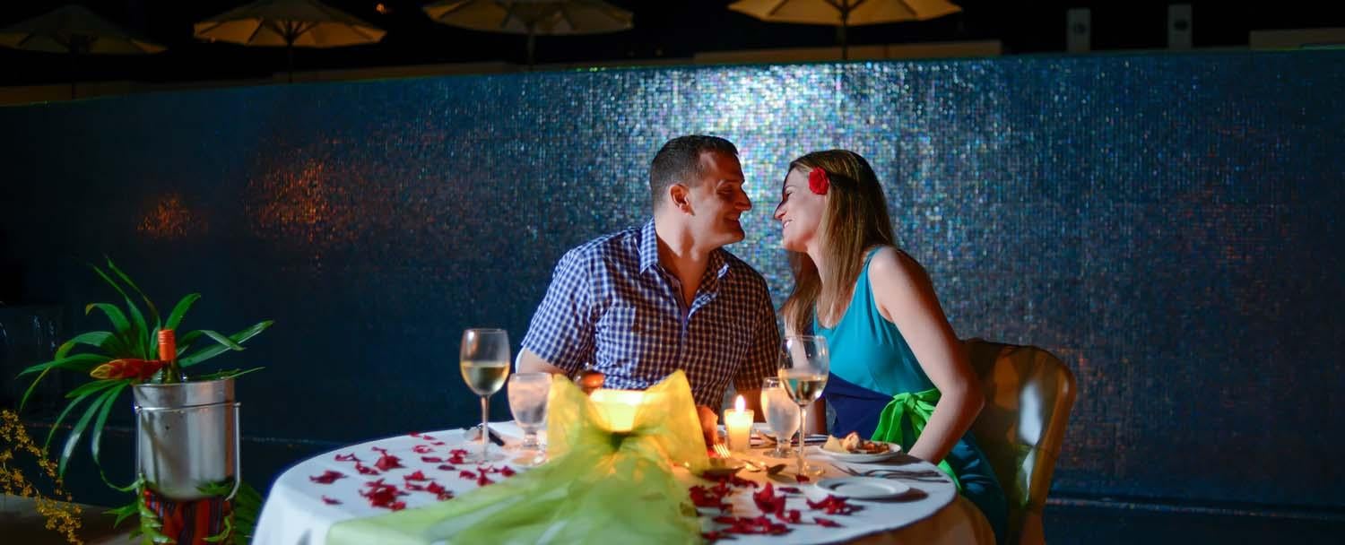 Couple enjoying a romantic dinner under the stars during Belize honeymoon at chaa creek resort